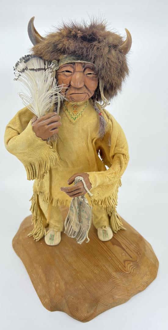 Shona-Hah Lelooska Crow Indian Buffalo Warrior: 14" tall, 10" long, 8 1/4" wide. Shona-Hah is the mother of Lelooska, Kwunkwa-dzi, Patty Fawn, and Tsungani. She was born in a black walnut log cabin in Oklahoma?s old Cherokee Nation. There, she was 