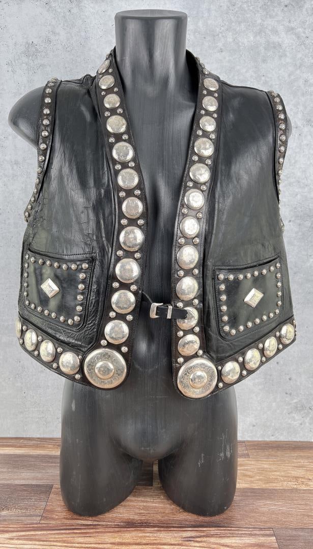 Edward Bohlin Sterling Concho Leather Cowboy Vest: Drop dead gorgeous old vest. Fully emblazoned in Sterling Silver Conchos. Nice early vest, tag has both the Hollywood and the Palm Springs locations listed. 20" long, 21" armpit to armpit. Institution