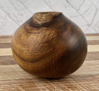 Michael Lee Hawaii Carved Koa Wood Vase: 4 1/2" tall, 5 1/2" diameter. Mike Lee is Hawaii born and raised, and it shows. An avid surfer and waterman, he gets a lot of the inspiration for his wood carving from the ocean. An excellent and pati