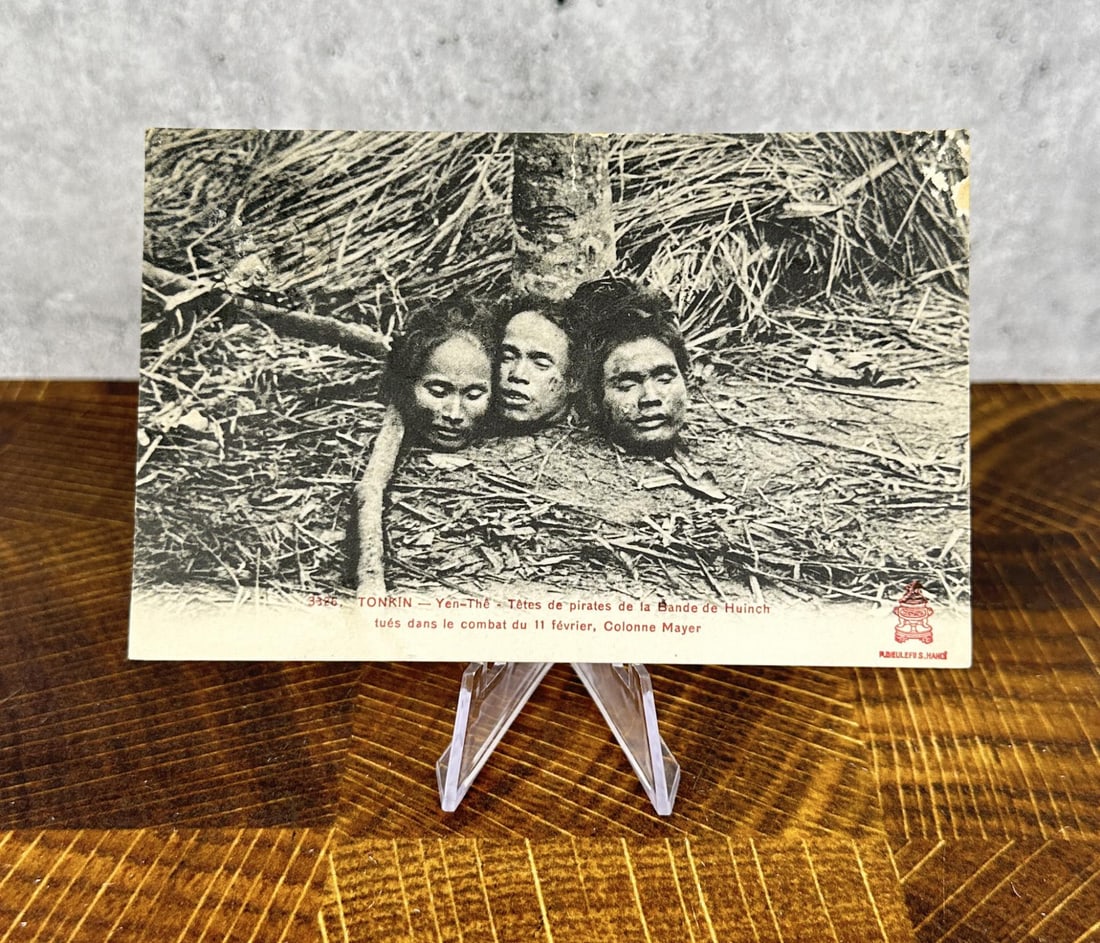 French Indo China Postcard Of Severed Heads: Text on the front translates as - 3386. TONKIN-Y?n-The Heads of pirates of the Huinch Band killed in the combat of February 11, Mayer Column. 5 1/2" by 3 1/2".