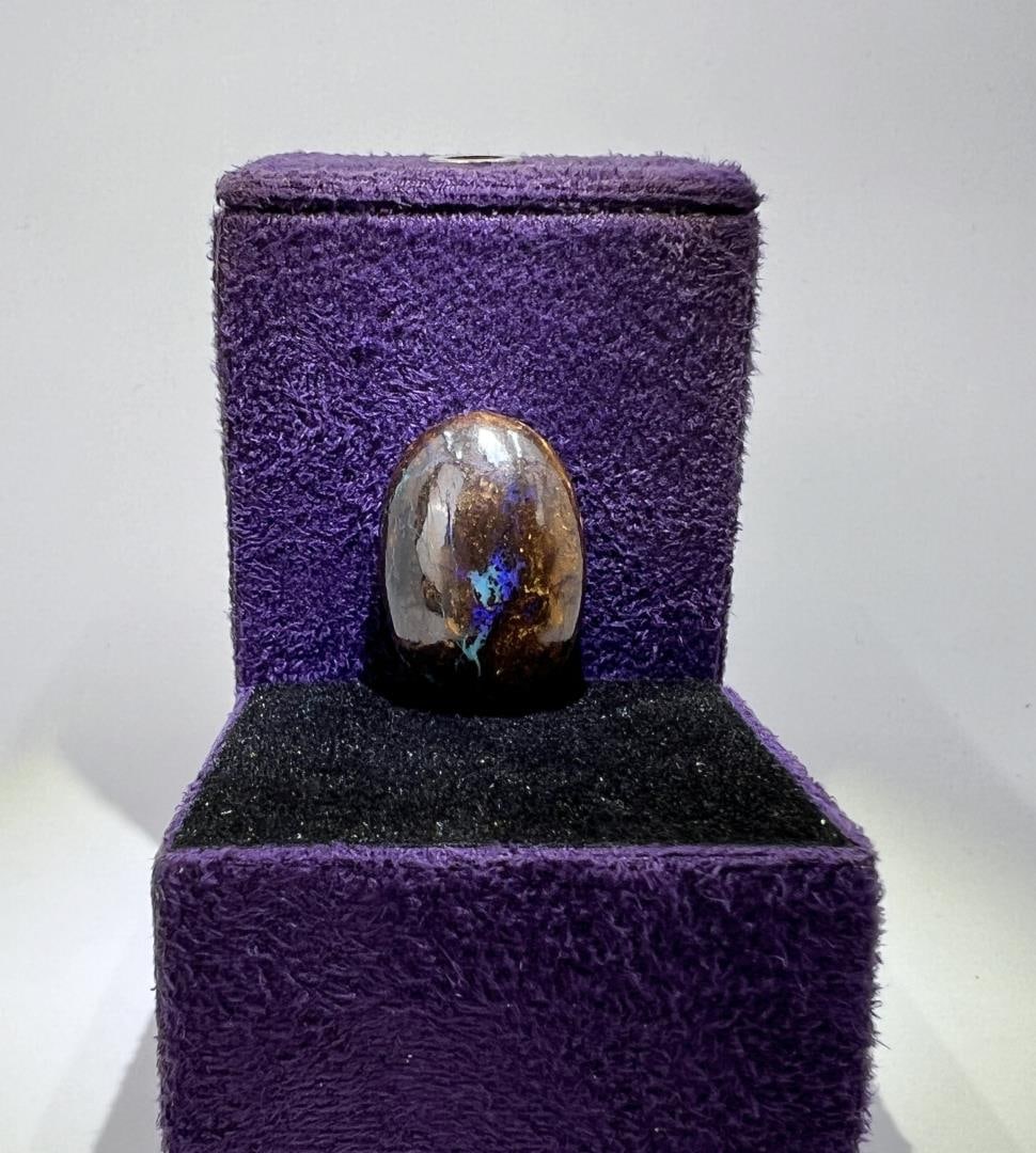 24.6 Carats of Australian Black Boulder Opal: 4.9 grams or 24.6 carats. 3/4" by 1/2".