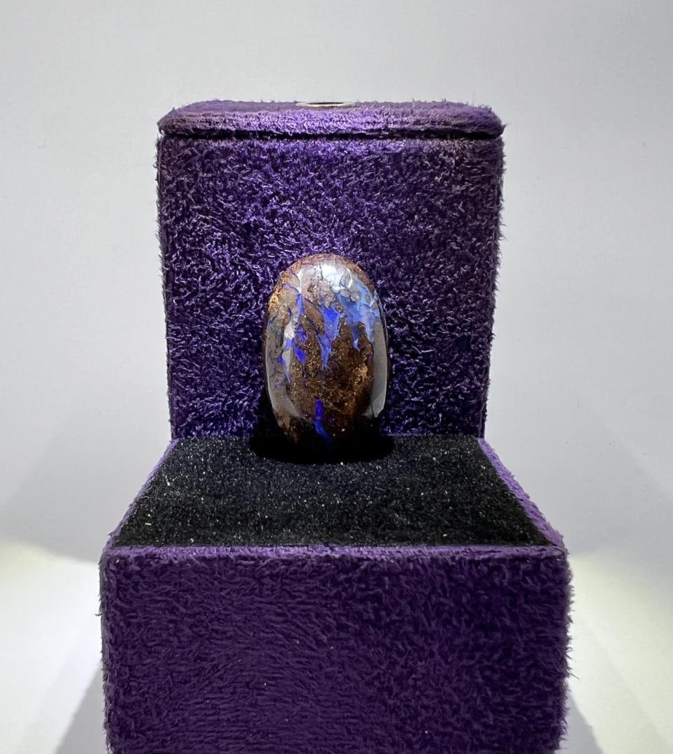 24.8 Carats of Australian Black Boulder Opal: 4.95 grams or 24.8 carats. 1" by 1/2".