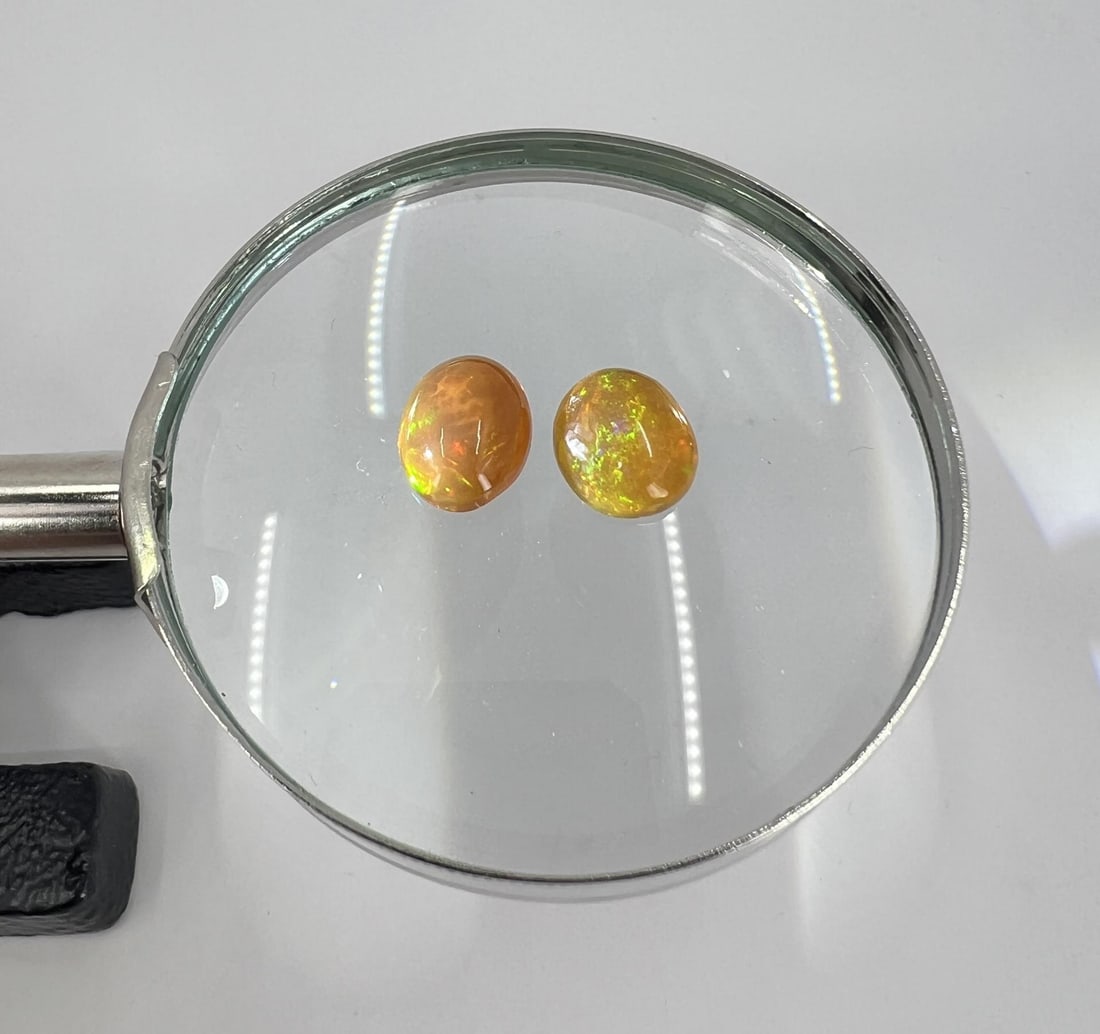 6.8 carats Ethiopian Opals: Two opals. 1/2" by 1/4". Combined weight 1.35 grams or 6.8 carats
