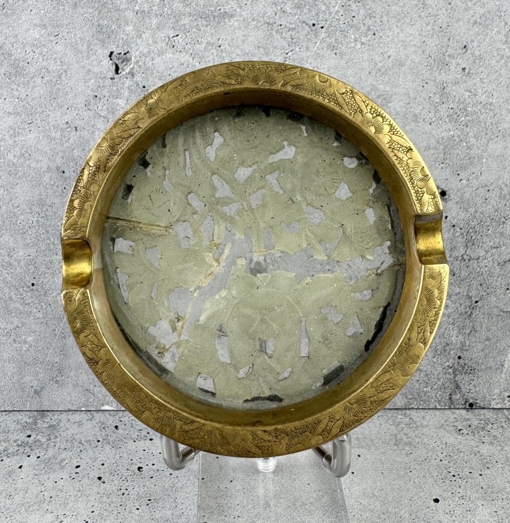 Chinese Brass And Carved Jade Ashtray: 3/4" tall by 3 3/4" in diameter. Jade inset is cracked