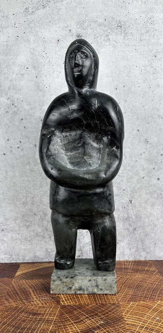 Tuna Iquliq Inuit Eskimo Soapstone Carving: 17" tall by 6" wide by 4 3/4" deep Tuna Iquliq (1935 - 2015) was active/lived in Nunavut / Canada. Tuna Iquliq is known for Inuit sculpture and drawing. A prominent Canadian Inuit sculptor and draftsm