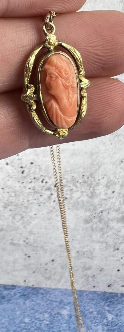 Angelskin Coral Cameo Necklace: 10" long.