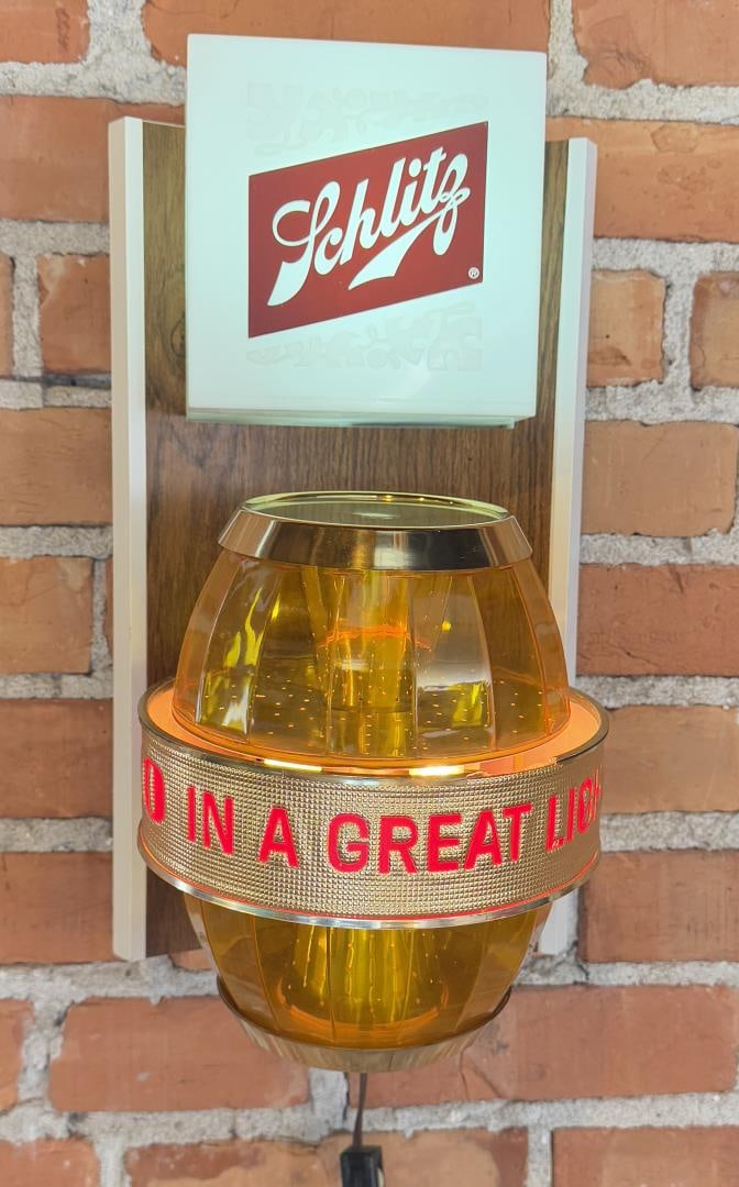 Schlitz Lighted Beer Barrel Sign: 16 1/2" by 9 1/2" by 9". Only the top of the barrel spins, not fully functional. Cracked lens.