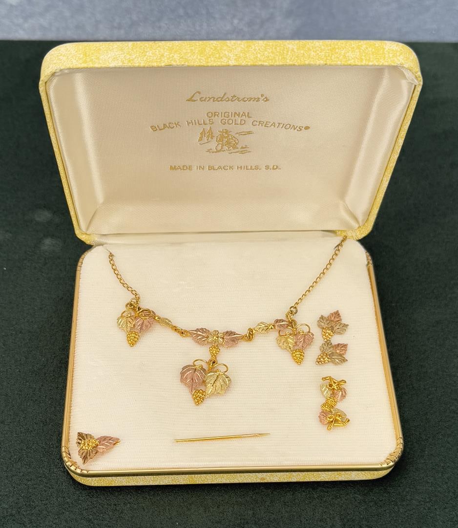 Landstrom's 10k Black Hills Gold Necklace Suite: Necklace, earrings, stick pin. 7.97 grams. This lot requires payment via non credit card.