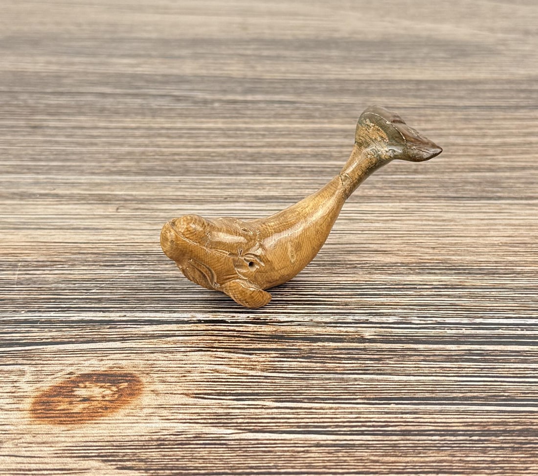 Alaskan Inuit Eskimo Carved Whale: 3 1/8" by 1 1/2" by 1 1/2". Tail has been broken and repaired. Carved walrus material. Native made prior to 1972. This item cannot be shipped to Oregon, California, Hawaii, New York, New Jersey, Inter