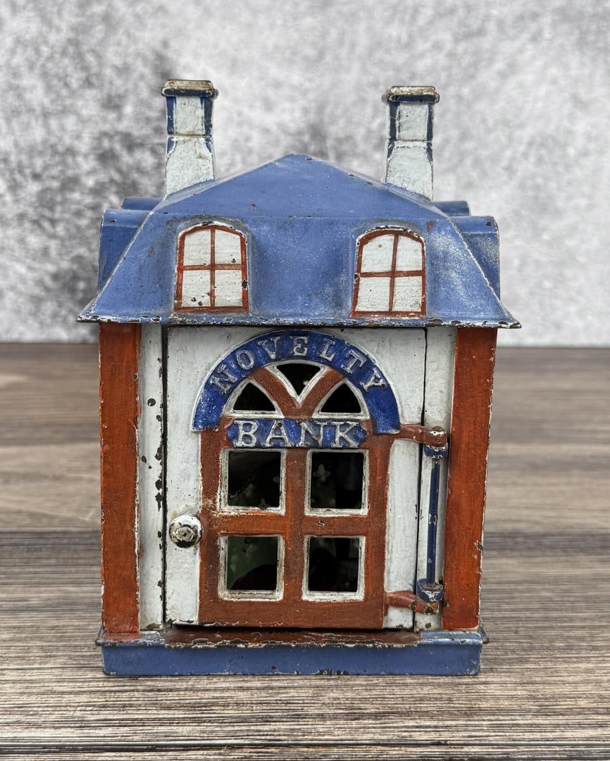 J&E Stevens Mechanical Cast Iron Novelty Bank: Bank is in working condition. Has original paint. Measures 6 1/2" by 4 3/4" by 4 3/4"