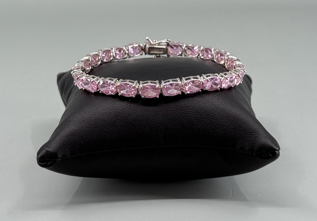 Sterling Silver Pink Tennis Bracelet: 7 3/4" long open. 18.05 grams.