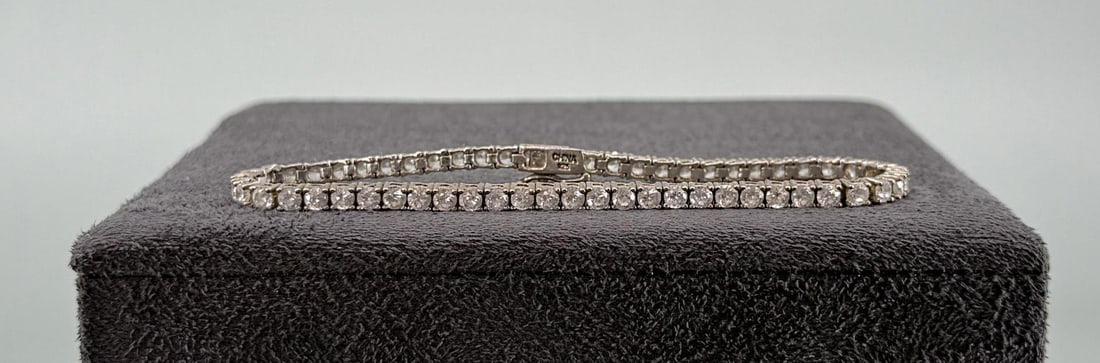 Sterling Silver CZ Tennis Bracelet: 7 3/4" long. Weighs over 9.25 grams.