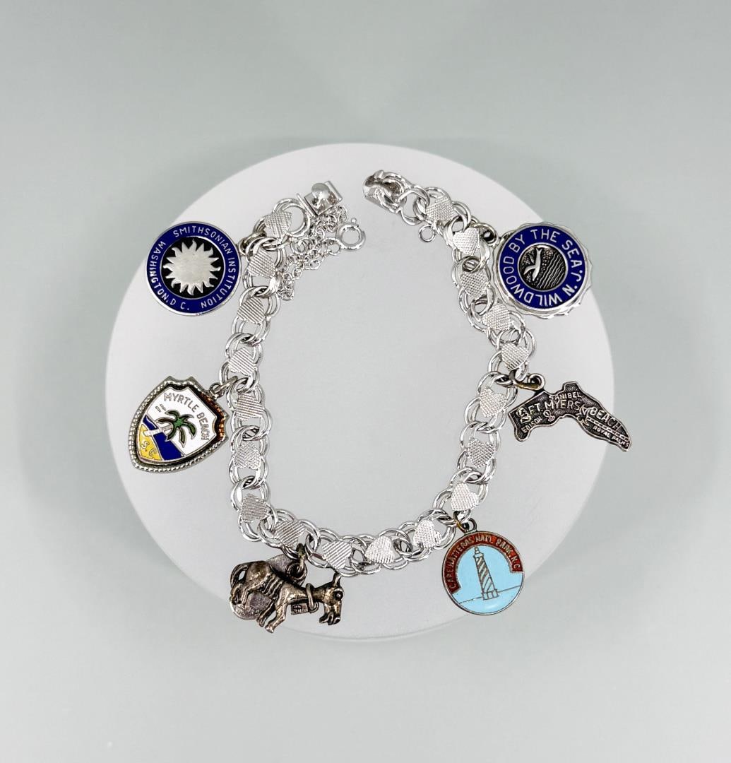 Sterling Silver Charm Bracelet: 7 5/8" long open. 25.30 grams.