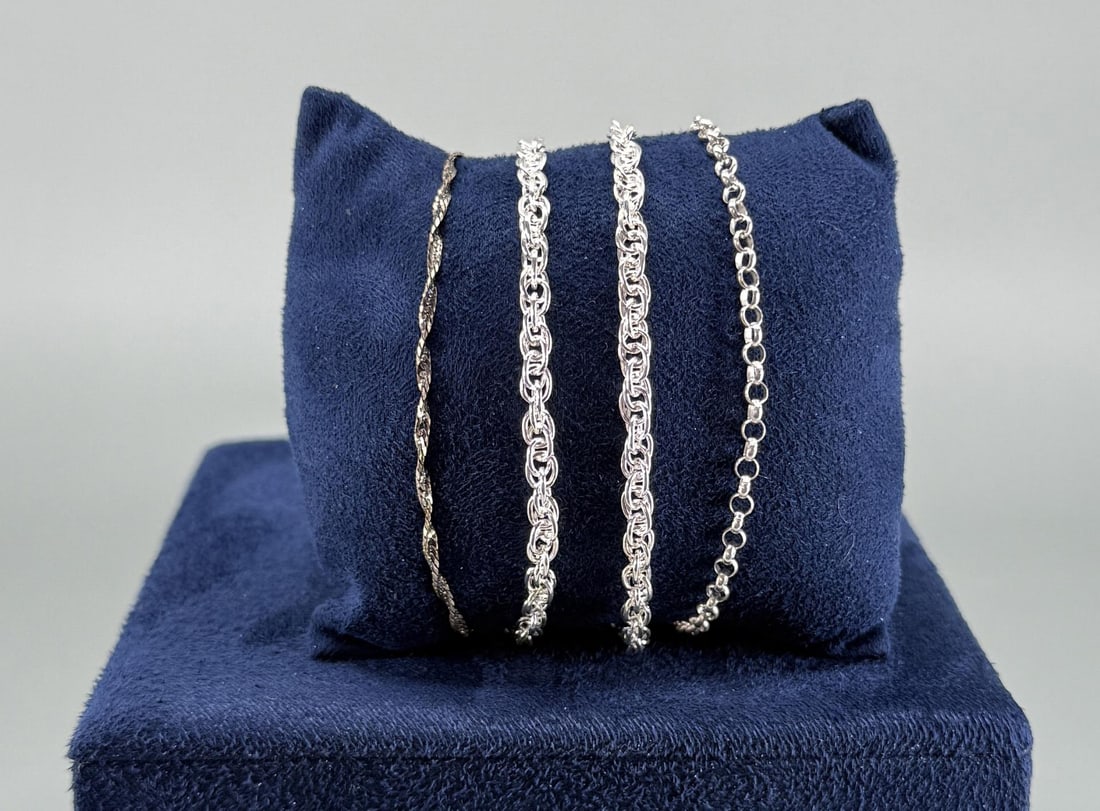 Group Of Sterling Silver Chain Link Bracelets: Four total. 17.55 grams combined weight. Longest measures 7 3/4" long open.