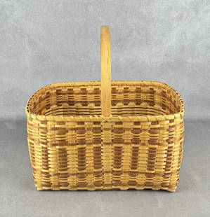 Emily Smith Cherokee Indian Market Basket: 17" by 16 5/8" by 11 5/8". Emily Smith makes white oak baskets and honeysuckle baskets with materials gathered from the woods and dyed with natural dyes. She can demonstrate basketry, or she can