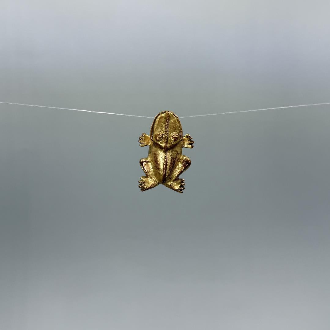 Pre Columbian Tairona Tumbaga Frog Pendant: 1 1/2" by 1". XRF machine tests as 86% Copper, 12% Gold. Provenance: From the estate of Iris Apfel. Apfel August 29, 1921 ? March 1, 2024 was an American businesswoman, interior designer, and fashion