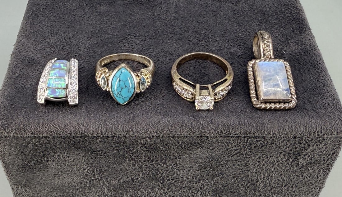 Grouping of Sterling Silver Jewelry: Moonstone pendant is 1 1/4" long. Rings are size 7 /12 and 8. 24.03 grams.