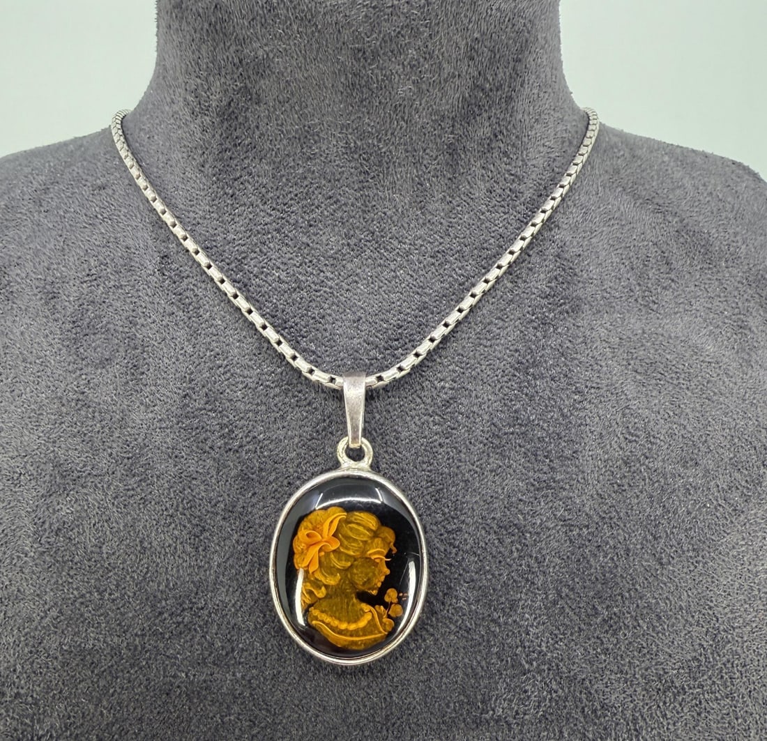 Sterling Intaglio Carved Amber Cameo Necklace: 13.82 grams. 10 1/4" long closed.