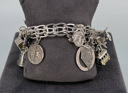 Impressive Sterling Silver Charm Bracelet: 88.52 grams. 7 3/4" long open.