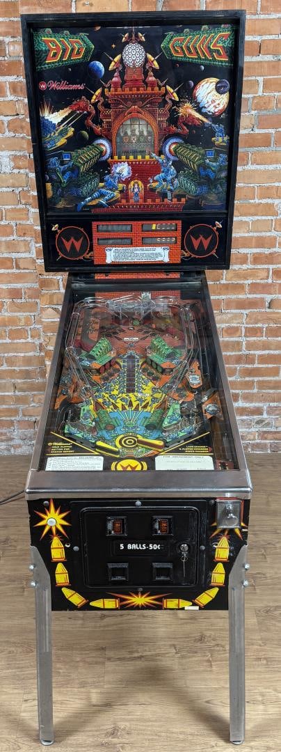 Williams Big Guns Pinball Machine: Operational, all keys included as well as original manual, some extra parts. Flippers work, however right flipper becomes stuck occasionally. Some lights need to be replaced on the playfield. Music an
