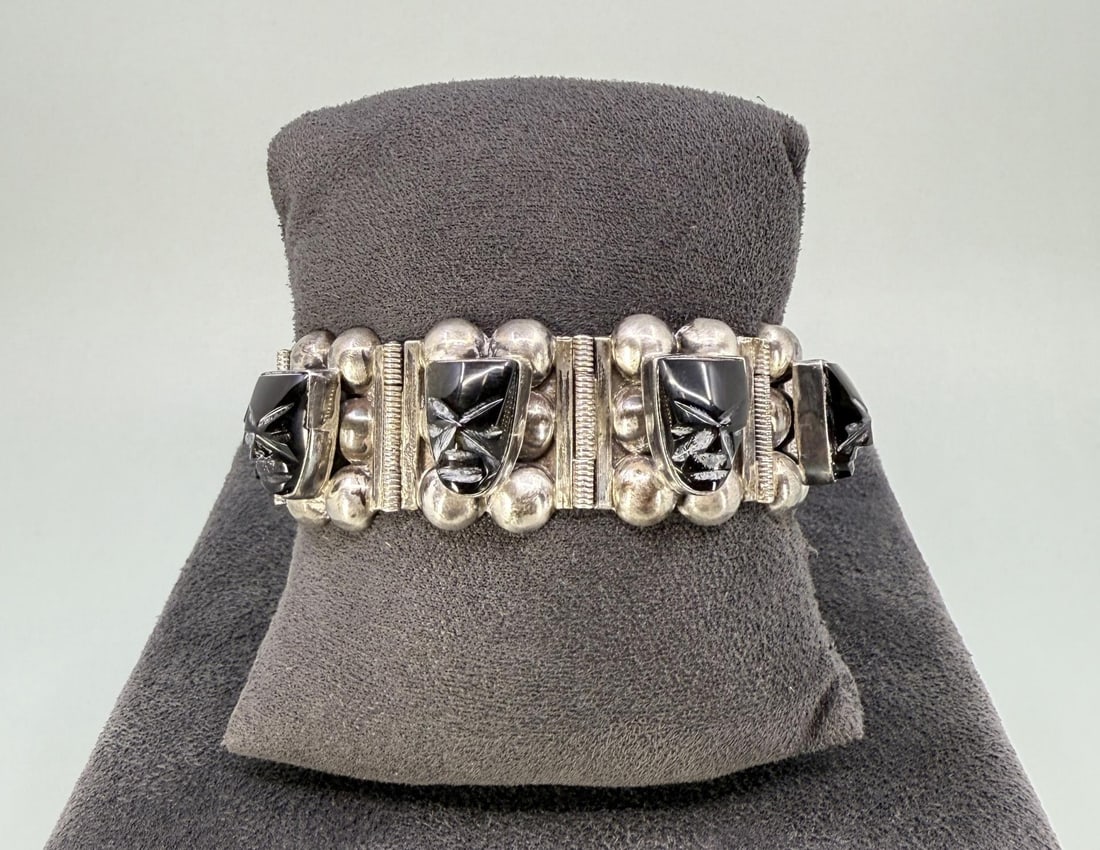 Taxco Mexico Sterling Silver Onyx Aztec Bracelet: 52.90 grams. 7 5/8" open.
