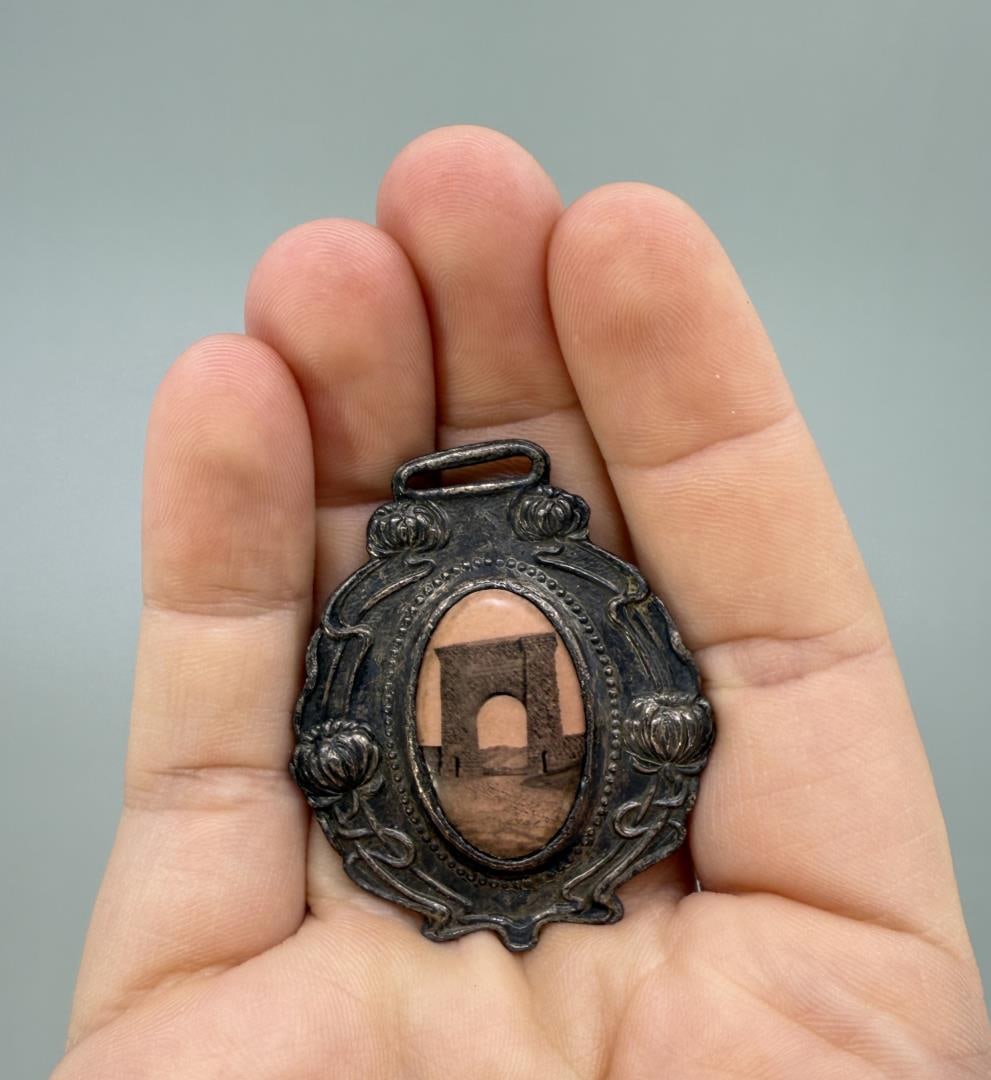 M.S.S.A Tournament Watch Fob Livingston Montana: 15th Annual Tournament. Yellowstone Park Gate Celluloid Picture Front. 1 7/8" long.