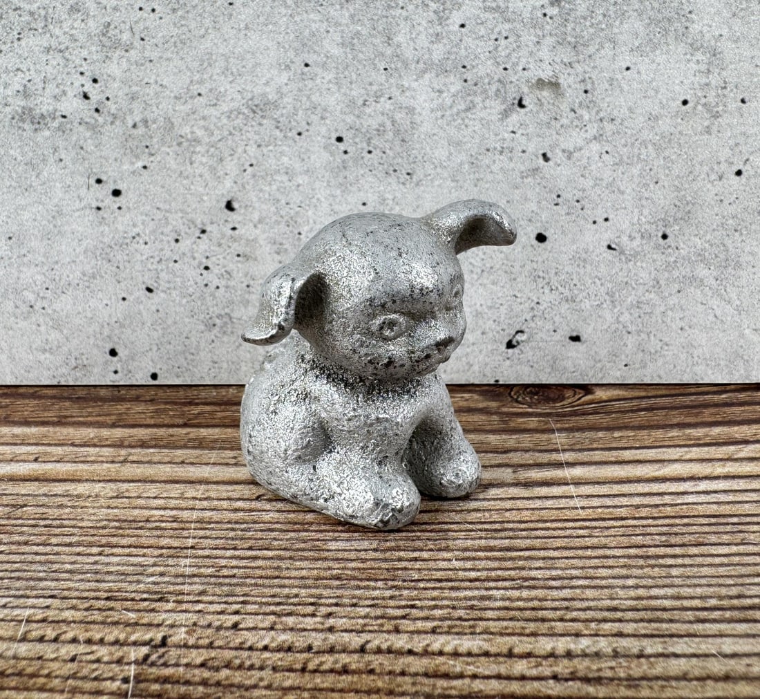Bucki Carbons Ribbons Aluminum Dog Paperweight: 1 1/2" diameter, 1 3/8" tall.