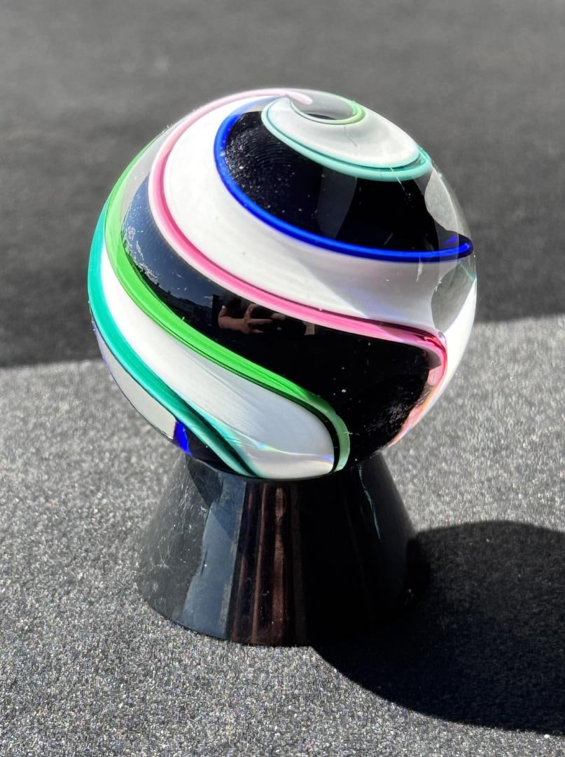 Fritz Lauenstein Art Glass Marble: 2" Diameter. Fritz Glass is owned & operated by the husband & wife team of Fritz Lauenstein and June Raymond. Fritz started blowing glass in 1974 at Gould Academy in Bethel, Maine. He then attended Go
