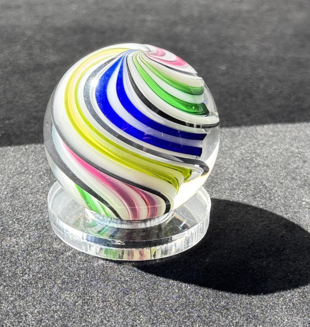 Fritz Lauenstein Art Glass Marble: Measures 1 1/2" in diameter. Fritz Glass is owned & operated by the husband & wife team of Fritz Lauenstein and June Raymond. Fritz started blowing glass in 1974 at Gould Academy in Bethel, Maine. He