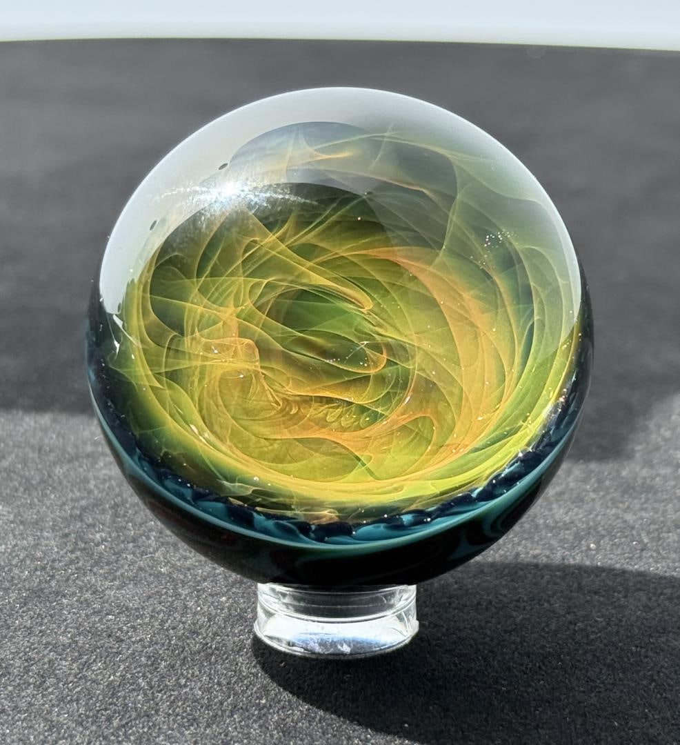 Bill Grout Vortex Pixie Galaxy Art Glass Marble: Signed WCG 17. Pixie Hair Starlight. 2" in diameter. Bill Grout is a master glass artist specializing in the creation of intricate borosilicate vortex marbles. He began his journey in flame-working in