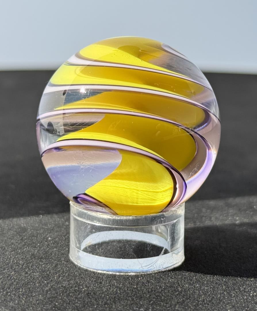 Fritz Lauenstein Art Glass Marble: 1 1/2" Diameter. Fritz Glass is owned & operated by the husband & wife team of Fritz Lauenstein and June Raymond. Fritz started blowing glass in 1974 at Gould Academy in Bethel, Maine. He then attende
