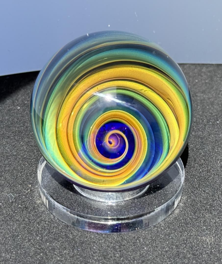 Jason Holley Borosylicate Fumed Galaxy Marble: 1 5/8" diameter. Signed and dated 2017. Jason Holley is a distinguished American glass artist known for his breathtaking craftsmanship in the world of borosilicate glass marble making. Based in Califo