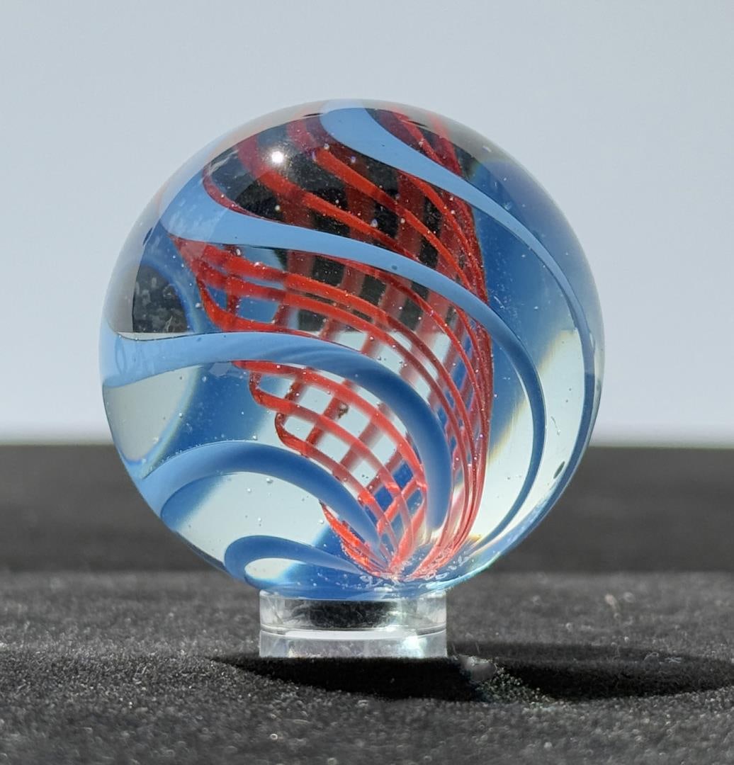 Sam Hogue Clear Cane Swirl Art Glass Marble: 1 3/4" in diameter. Signed Sam Hogue 2016. Sam Hogue affectionately known in collector circles as the "Hillbilly Marble Maker" or simply Sammy hails from Ellenboro in Ritchie County, West Virginia. He