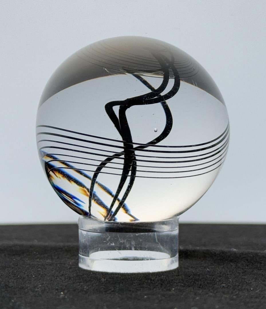 Little River Hot Glass Michael Trimpol Marble: 2" diameter. Michael Trimpol: Born in Philadelphia, PA, Michael Trimpol was first introduced to glass working during a high school stained glass course in Stowe, Vermont. He pursued a career in staine