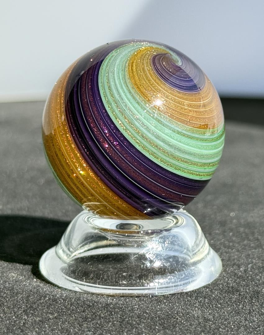 Rolf and Genie Wald Lutz Art Glass Marble: 1 5/8" diameter. Signed and dated 2017. Rolf and Genie Wald have been creating their colorful brand of furnace worked marbles up in the great Northwest for literally decades now, and the following for