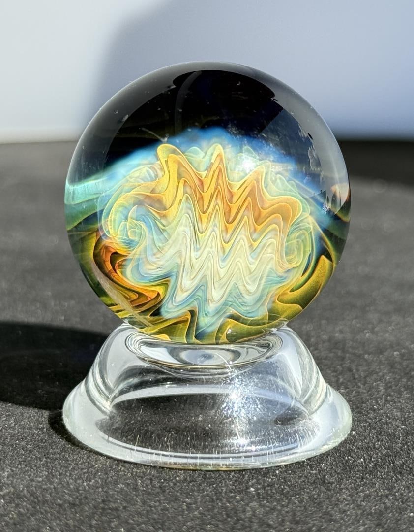 Jason Holley Borosylicate Fumed Galaxy Marble: 1 1/2" diameter. Signed. Jason Holley is a distinguished American glass artist known for his breathtaking craftsmanship in the world of borosilicate glass marble making. Based in California, Holley ha