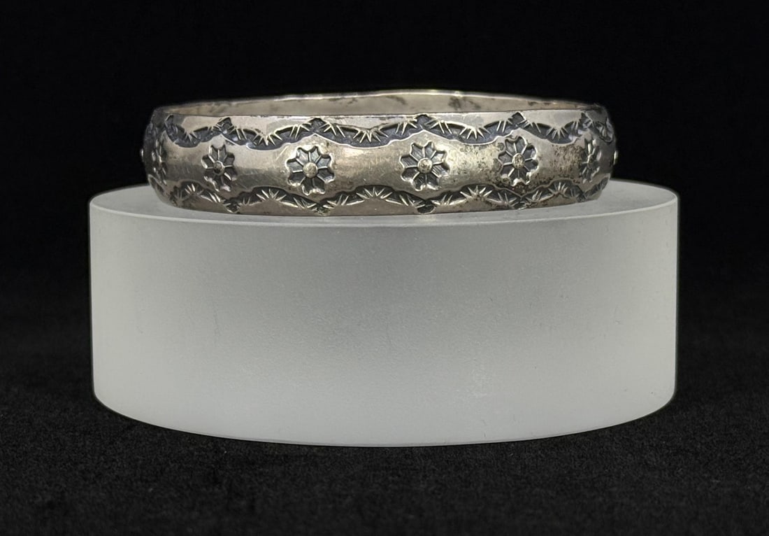 Henry Mariano Navajo Rug Stamped Sterling Bracelet: Cuff weights 36.2 grams. Measures 2 3/4" diameter.