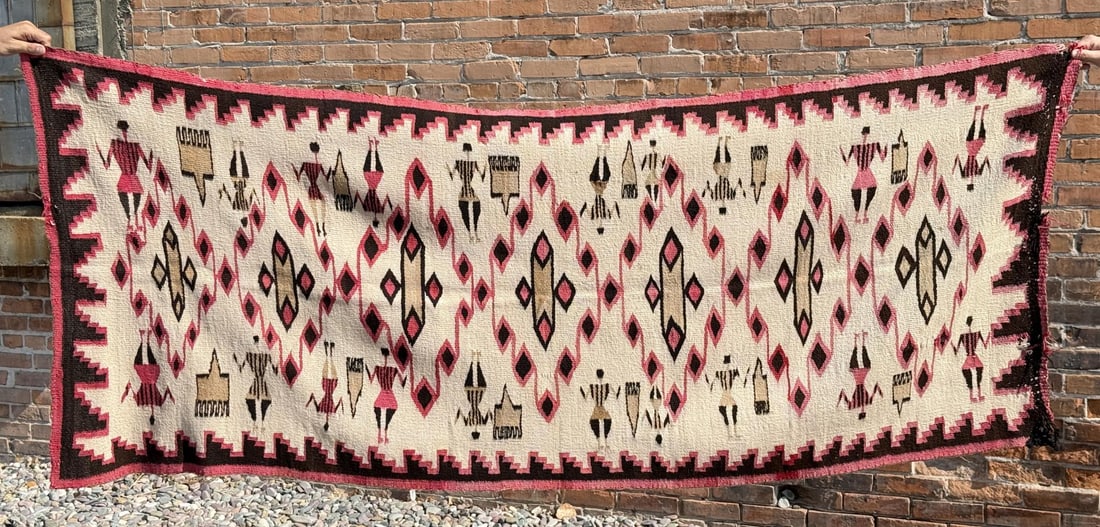 Transitional Navajo Pictorial Teec Nos Pos Rug: Unusual Pictorial Rug. Features Yei or Koshare figures standing next to wool combs. Appears to be Teec Nos Pos. 87 1/2" by 34".