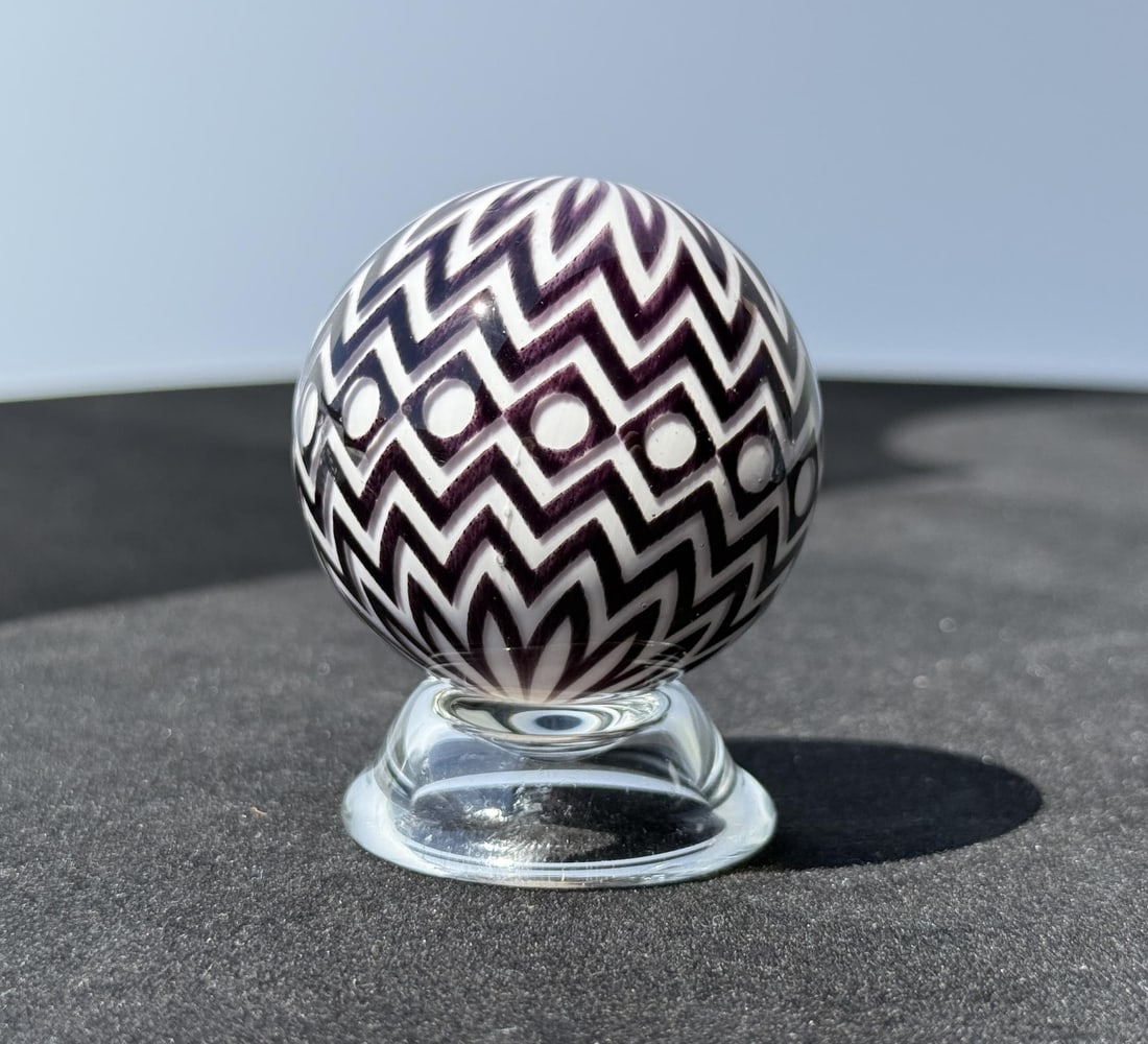 Mark Matthews Chevron Eye Art Glass Marble: 2" diameter. Signed and dated Matthews 2017. Black and White Graal Sphere. Mark Matthews is notably recognized for his work in glass, especially in glass spheres. Working with only one assistant, each