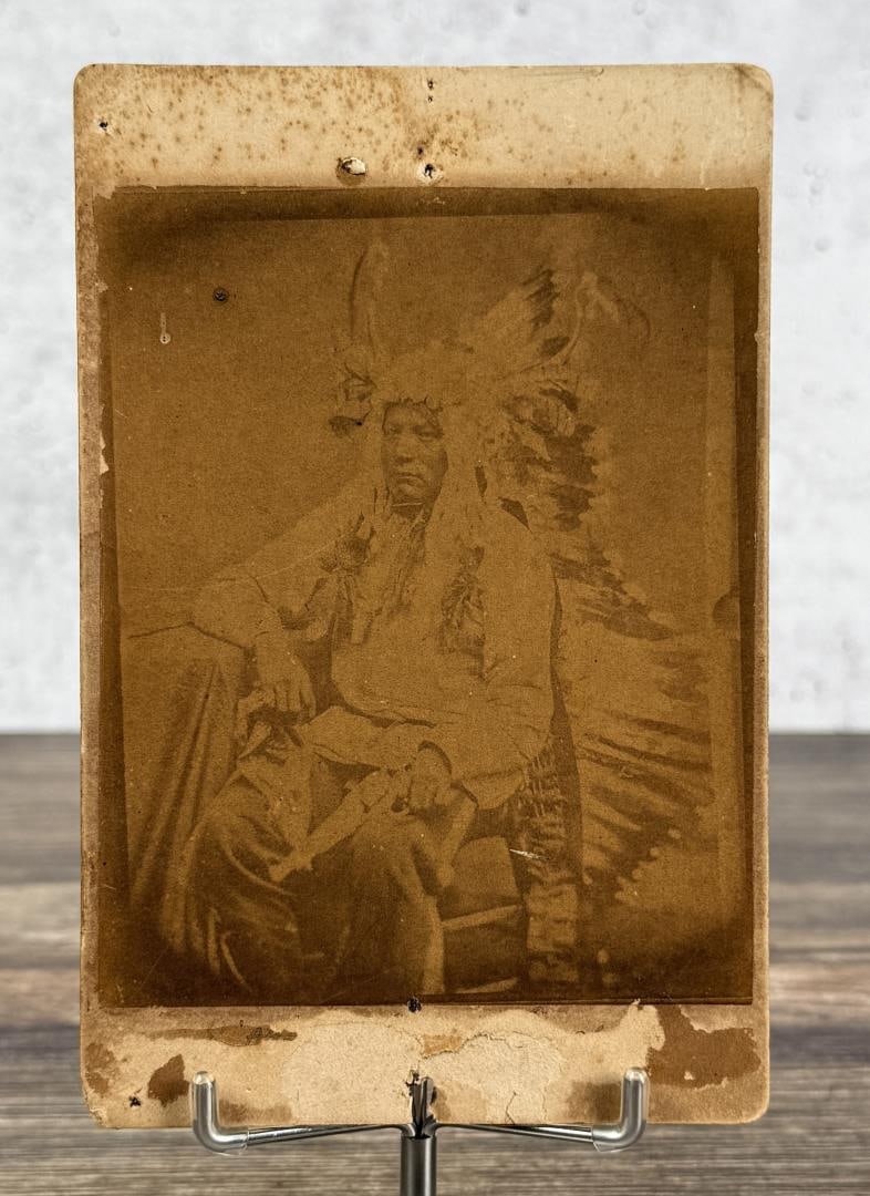 O.S. Goff Sitting Bull's Son Indian Photo: 4 1/4" by 6 1/2". Back of Cabinet Photo Reads Sitting Bull's Son; This man refused to have his picture taken unless his revolver was ready for immediate use.