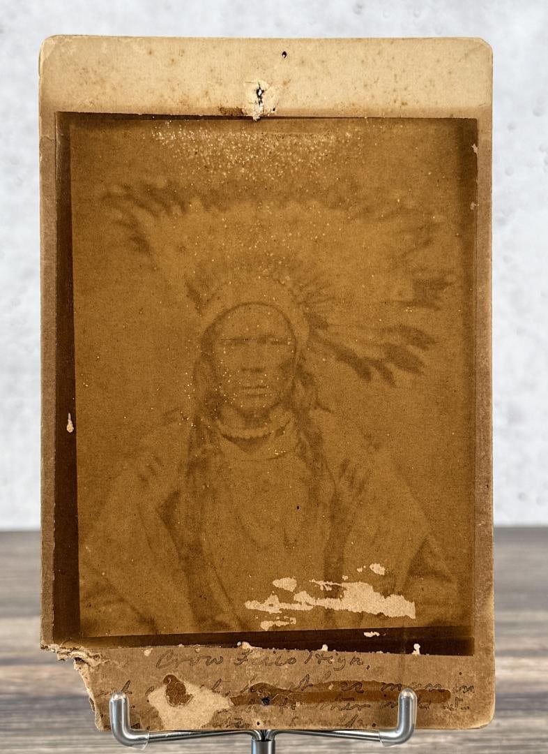 O.S. Goff Crow Flies High Indian Photo: 4 1/4" by 6 1/2". Back reads: Crow Flies high most cruel, heartless man in his tribe (each feather denotes a scalp). Crow Flies High (Hidatsa: Beericga Maaguhdaa Neesh; ca. 1830s-1900) was the chief o
