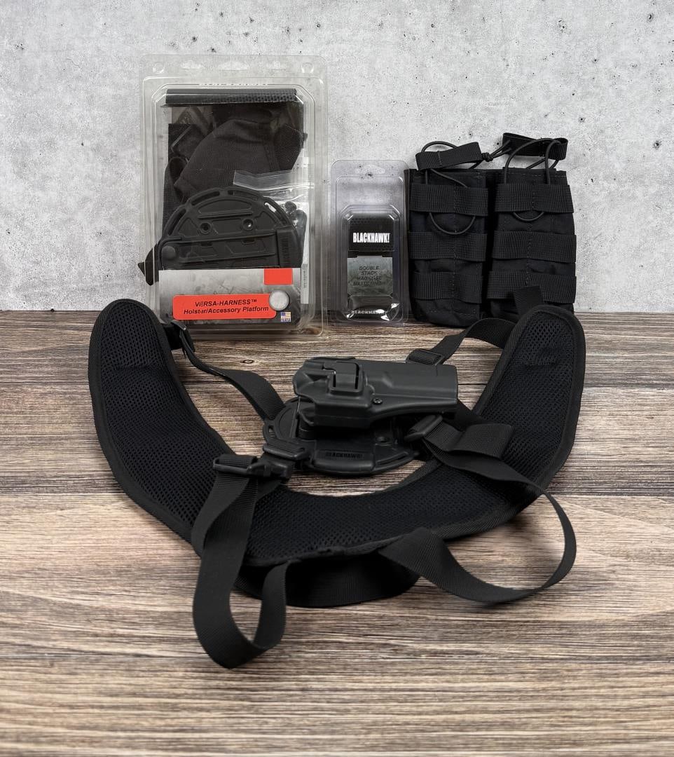 Blackhawk Tactical Handgun Accessories: Lot includes two Versa-Harnesses one in the package, the other mounted with a Glock 17/22 holster. Two mag pouches and one Double Stack Case Case in the package.
