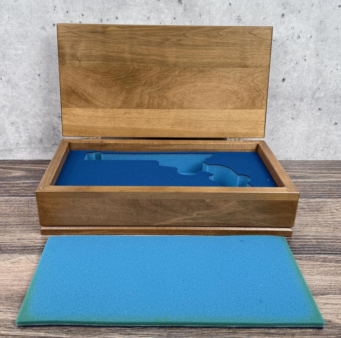 John Wayne Signature Colt Revolver Wood Case: 14 7/8" by 8" by 3 5/8".