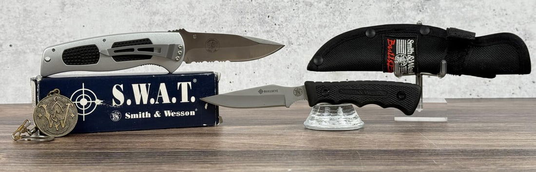 Pair of Smith & Wesson Knives: SW5000 Medium Serrated SWAT is new in box. The Bullseye is a CK301 Mini fixed blade and has never been used or carried. It is 6 3/8" long.