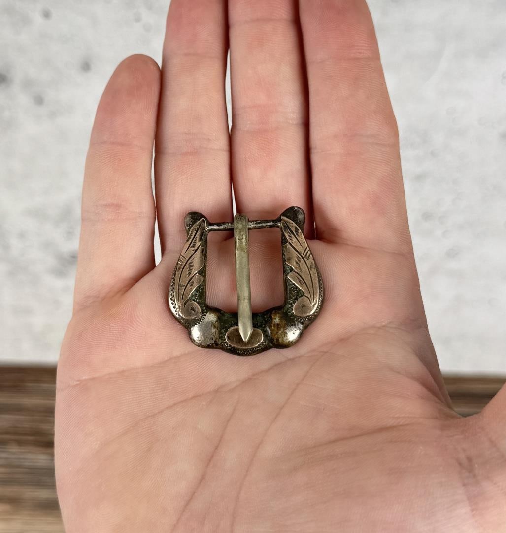 Sterling Silver Cowboy Belt Buckle: 1 3/8" by 1 3/8". 13.43 grams.