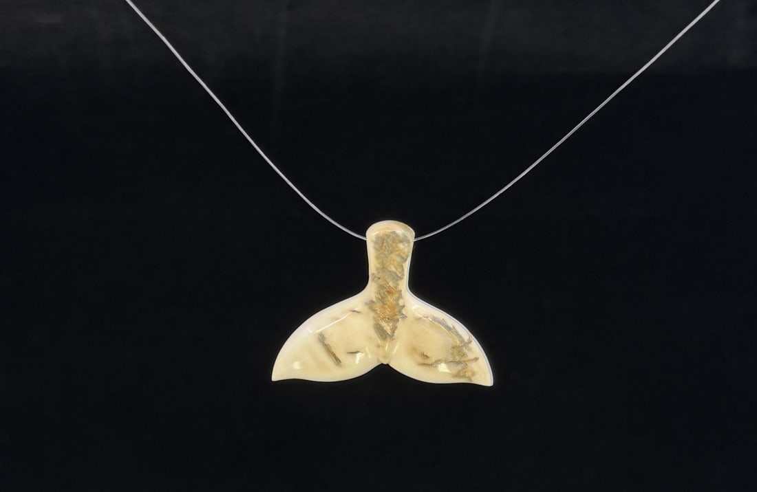 Alaskan Inuit Eskimo Fossil Ivory Whale Pendant: Whale Tail. 1 1/4" long. Native made prior to 1972. This item cannot be shipped to Oregon, California, Hawaii, New York, New Jersey, Internationally, or any other state that prohibits.