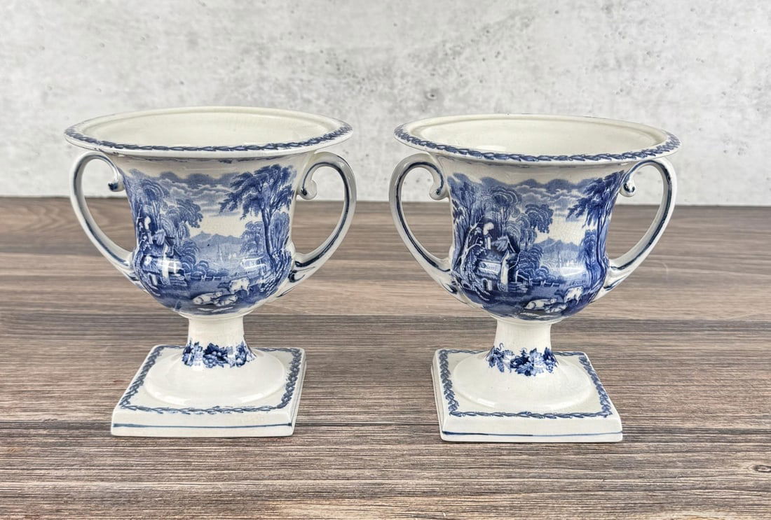 Pair of Booths British Scenery Footed Urns: Each piece has a 5 1/2" diameter and is 5 3/4" tall. One is cracked.