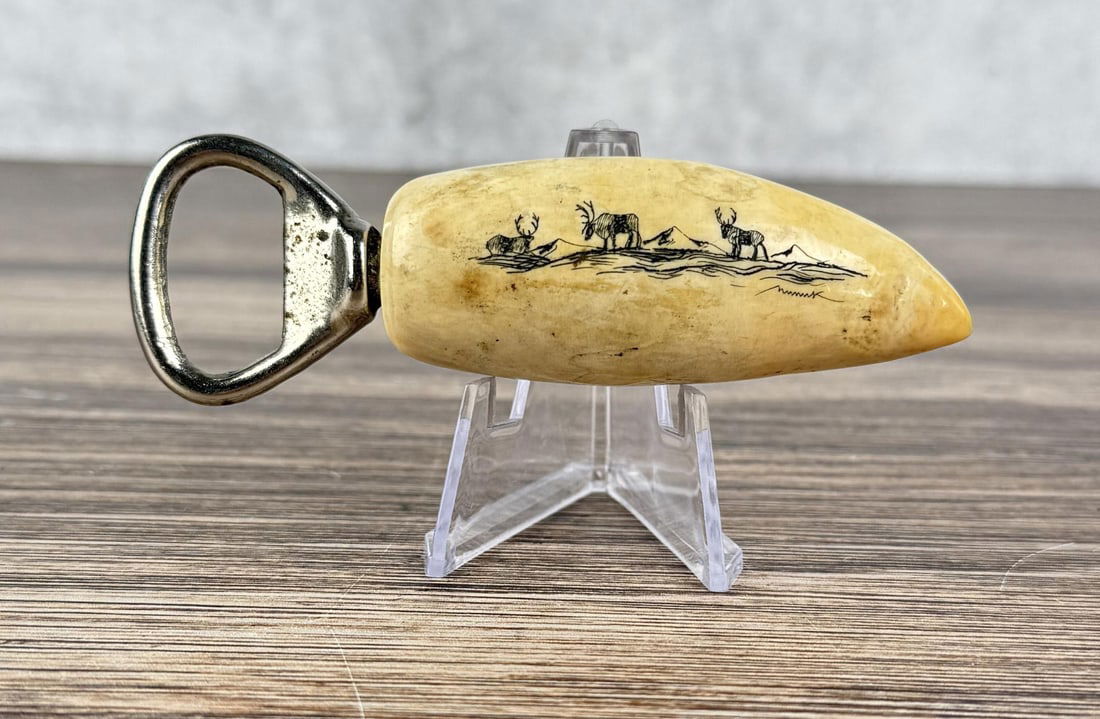 Alaskan Inuit Eskimo Scrimshaw Bottle Opener: 4 3/8" by 1 3/8" by 7/8". Carved Walrus Ivory. Native made prior to 1972. This item cannot be shipped to Oregon, California, Hawaii, New York, New Jersey, Internationally, or any other state that proh