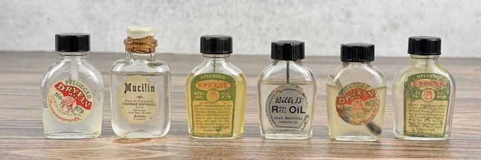 Group of Fishing Reel & Dry Fly Oil Bottles