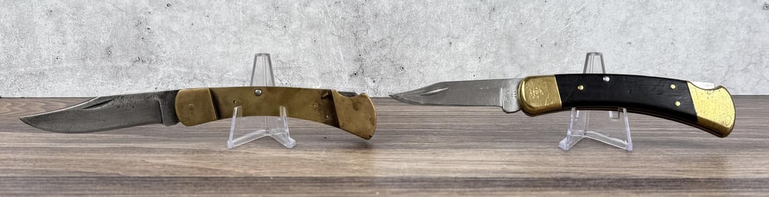Pair Of Buck 110 Pocket Knives: One missing scales.